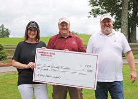 Members of The Foundation with a giant check