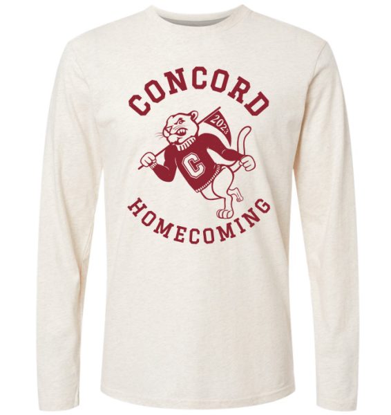 A white, long sleeve shirt with maroon lettering that says "Concord Homecoming". There is a Mountain Lion wearing a Concord shirt and holding a flag that says 2023