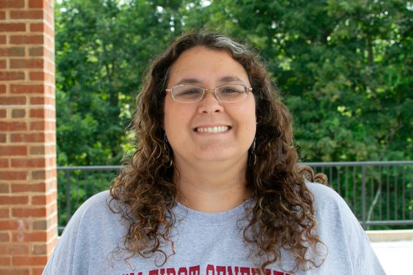 A photo of Heather Bennett, Concord University Student Support Services Administrative Associate, in front of a wooded backdrop.