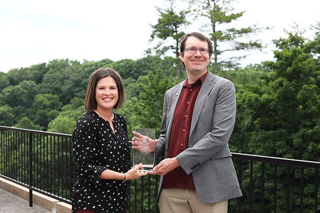 Lonnie Bowe receiving his CUAA award from Sarah Turner