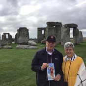 Bob and Eva Gallione holding Roar in front of Stonehenge