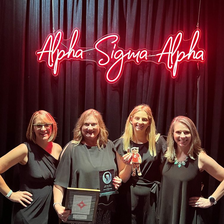 Janet Conroy and Alpha Sigma Alpha holding Roar