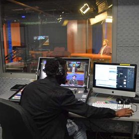 Communication-SQUARE A student operating the audio and visual booth for Mountain Lion News