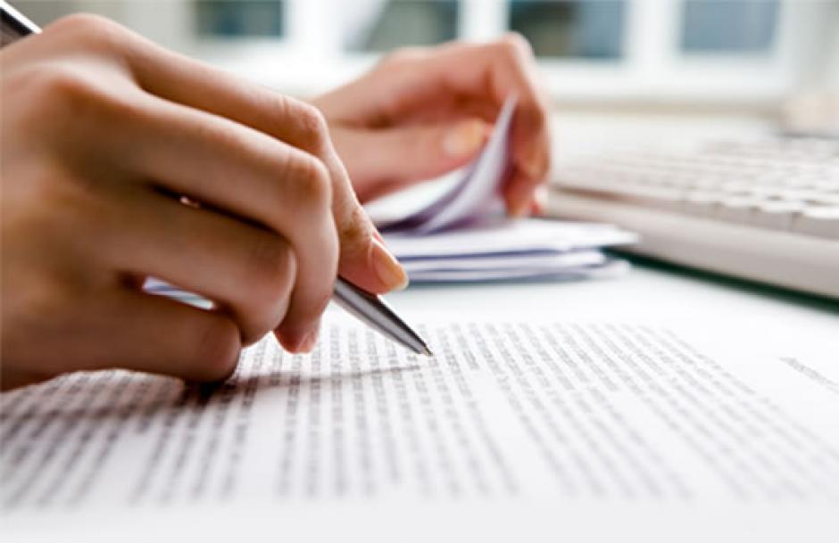 A person filling out forms and paperwork