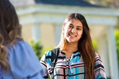 A girl smiling on campus