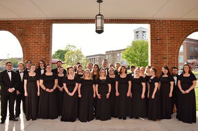 Col-Sgrs-Sp-19 A group photo of the Concord University choir outside of the Wilkes Chapel at University Point