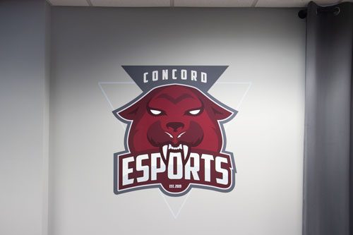 A wall with the Concord Esports logo on it