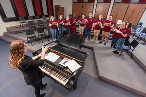 Dr. Kelly Hudson conducting the ConChords, Concord University's a capella group