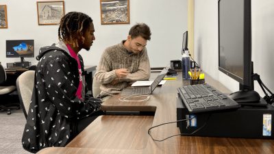 Two students working together on the computers in the Writing Center