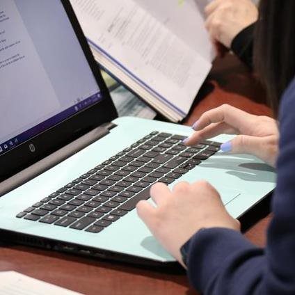 A student typing on their laptop