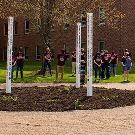 Students, faculty, and staff gathered around the peace poles at Concord University