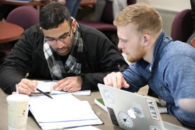 CK4A06881 Two Business Administration students working together on an assignment