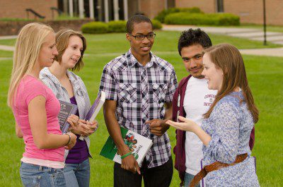 A group of students talking near the Fine Arts building