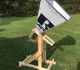 A photo of a radio horn telescope taken outside on a sunny day