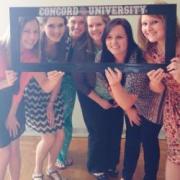 A group of psychology students posing with a Concord University sign