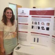 A Concord University psychology student standing next to her poster at the CU Research Festival