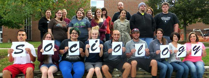 A group of students holding letters that spell sociology