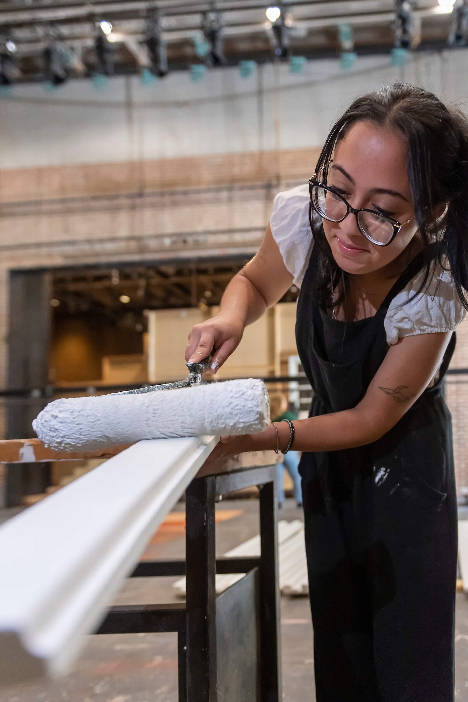 A Concord student painting a set