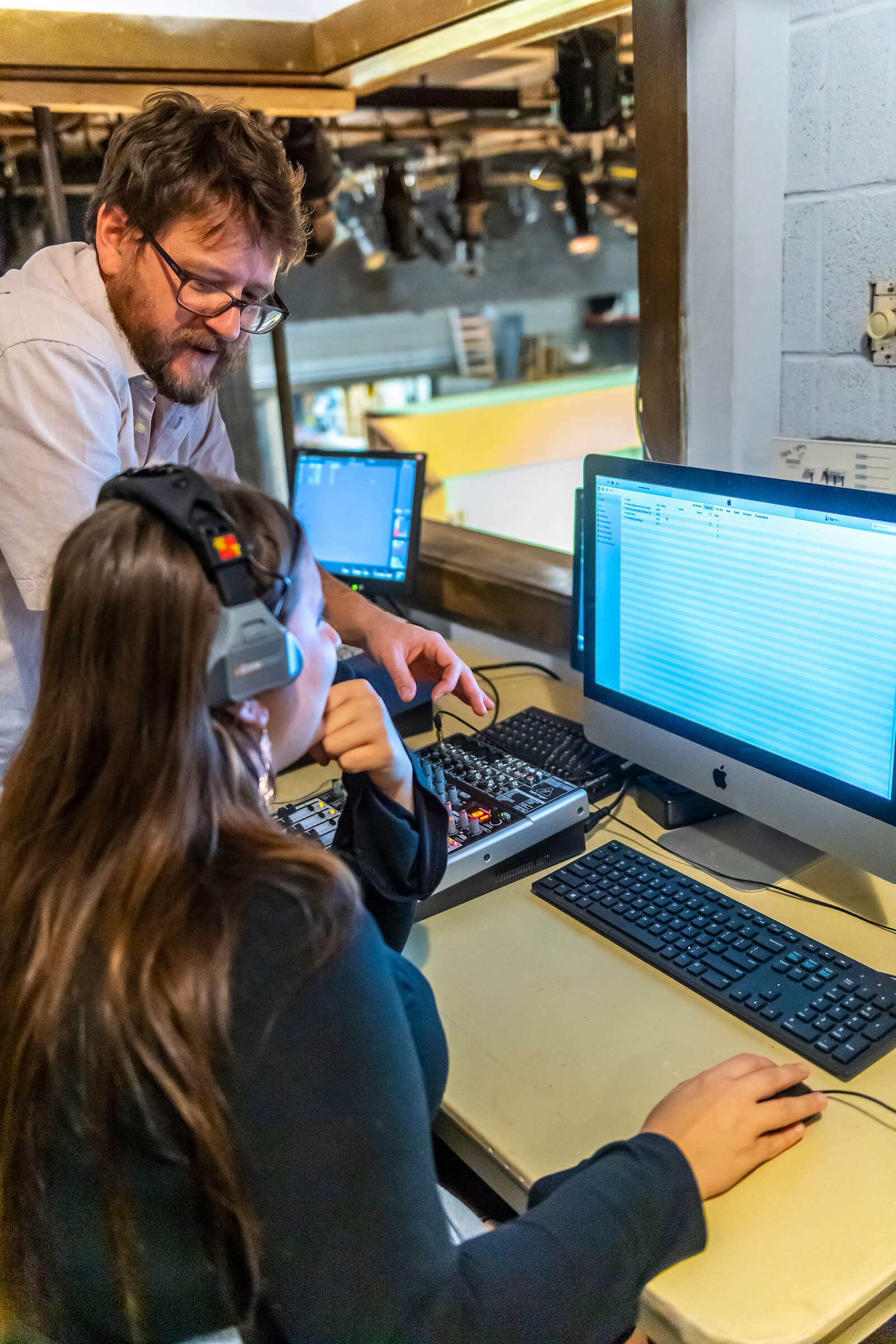 Professor Logan Regan and a Concord student working in the sound booth