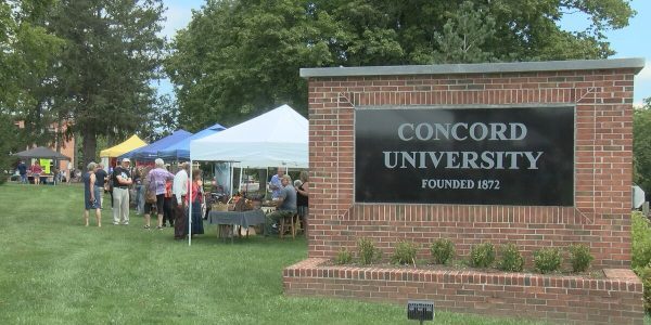 A photo of several community members visiting the tents on the front lawn of Concord University's campus during the Athens-Concord Town Social. The Concord University welcome sign can be seen on the right