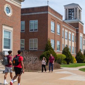 Students, faculty, and staff walking outside of Marsh Hall at Concord University.