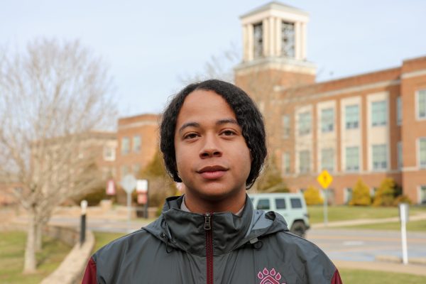 A photo of Marcus Wilson with Concord University's iconic bell tower in the background.