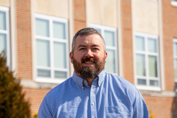 A photo of Eric Stovall standing in front on Concord University's Marsh Hall.