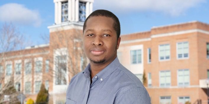 A photo of Rodney Tigaa, an Assistant Professor of Chemistry & Director of our CU Rise Accelerated Three Year Degree Programs, outside of Marsh Hall.