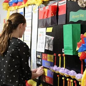 An education student decorating a bulletin board