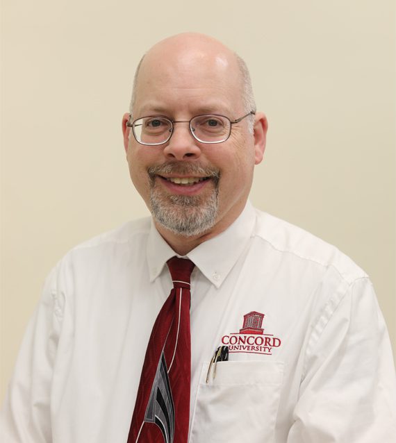 A photo of Jonathan Berkey in front of a neutral background