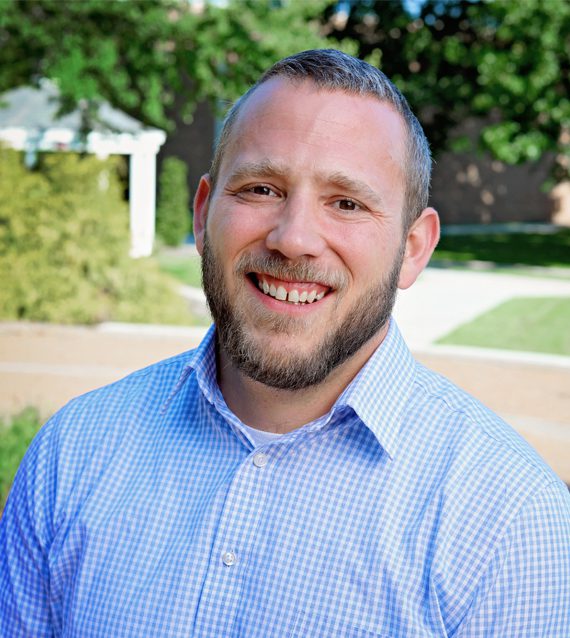 A photo of Scott Inghram in front of a gazebo on Concord University's campus