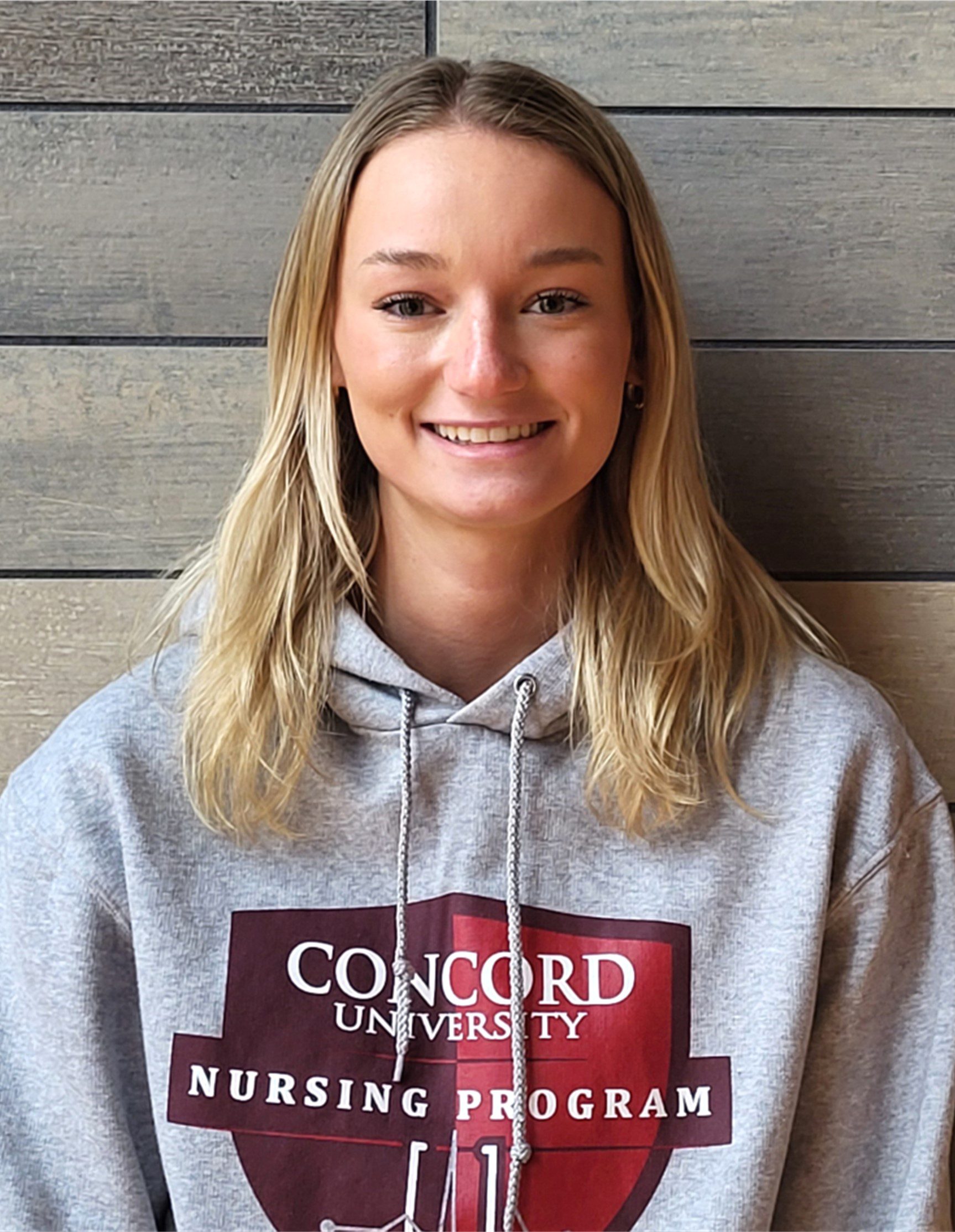 A photo of Shannon Phipps wearing a Concord University Nursing Program hoodie