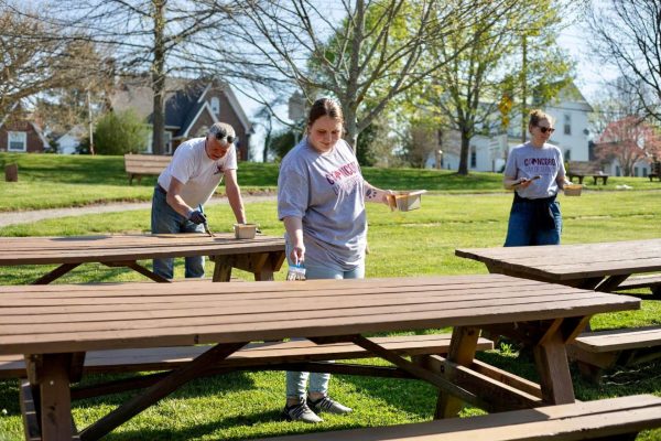 Concord University Bonner Scholars helping paint picnic tables at Athens Park during Concord's Day of Service