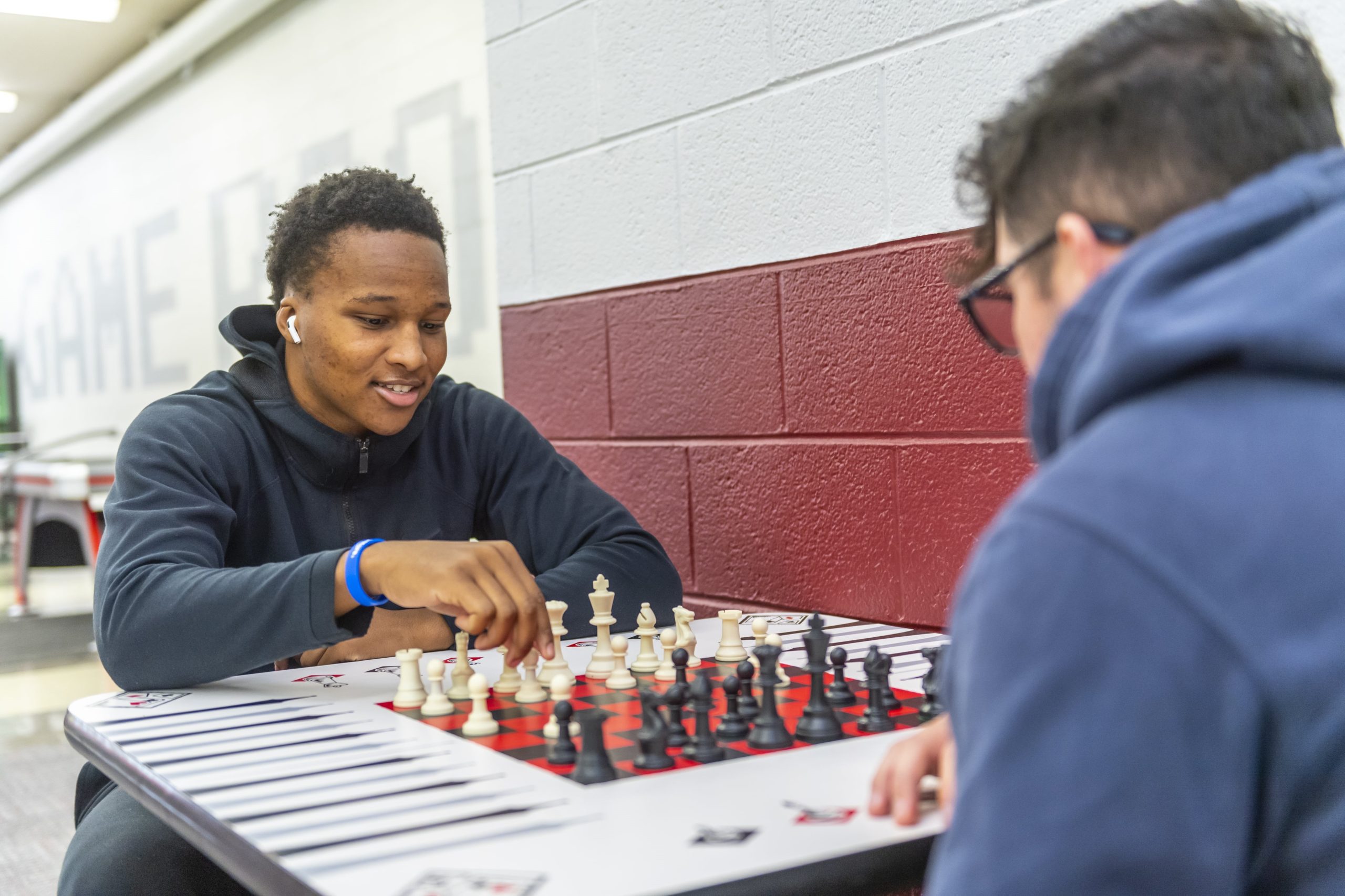 Two students playing chess in Concord University's game room