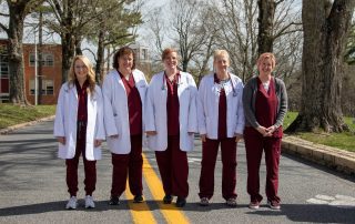 Members of the Nursing Department stand together in the entrance to the University. Members include (from left to right) Professor Amanda Nichols, Dr. Martha Snider, Dr. Michele Holt, Professor Danita Farley, and Krystle Land.
