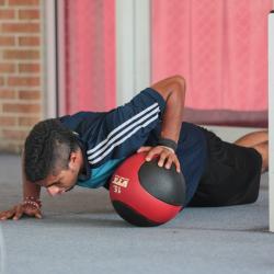 A student using an exercise ball in the fitness center