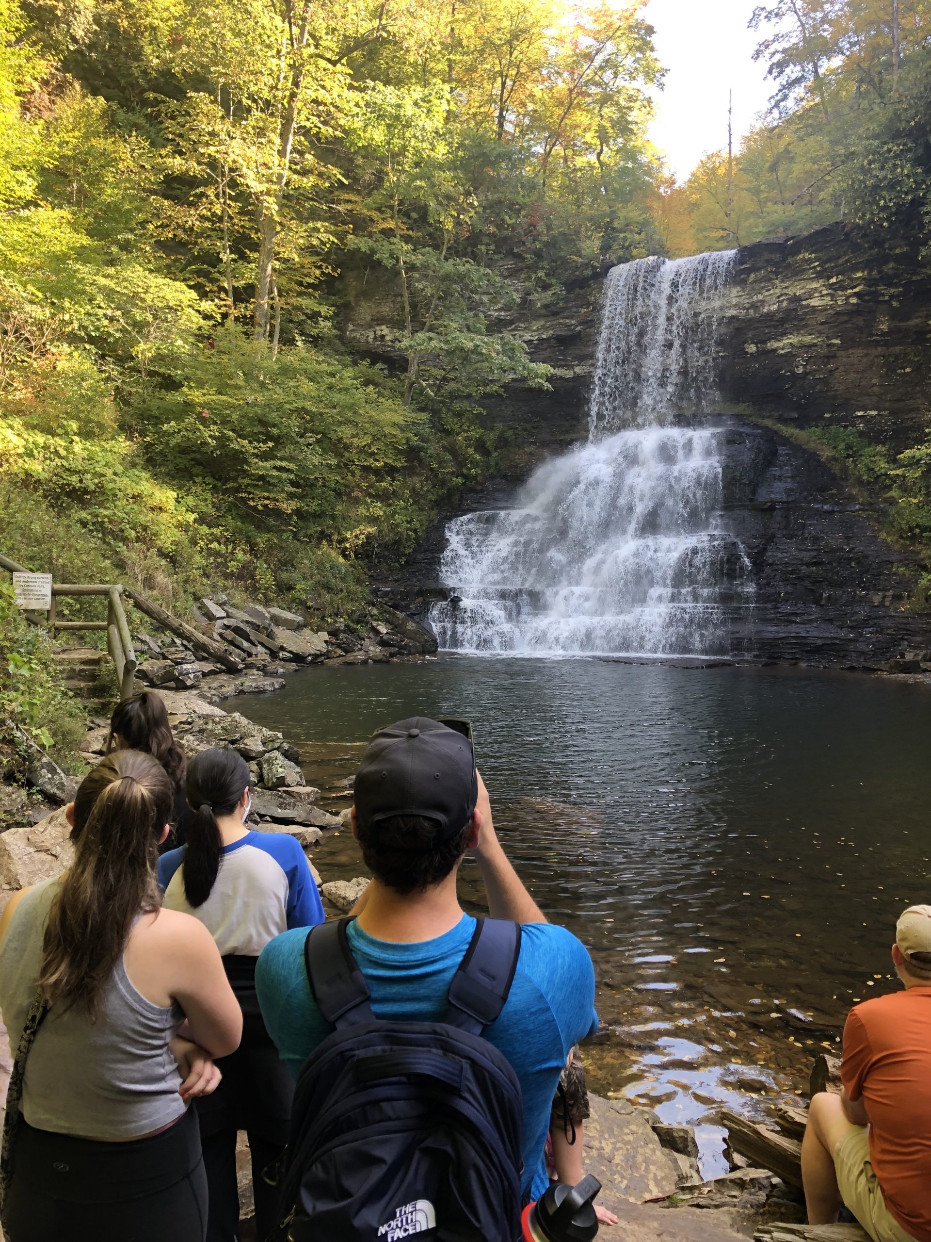 A group of students looking at a waterfall