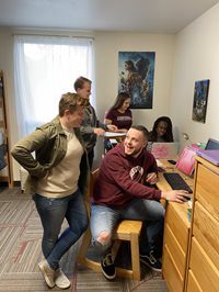 Students gathered around a desk in the towers residence hall
