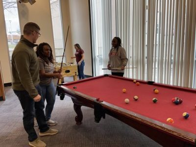 Students Playing Pool in the North Tower Residence Hall Lobby