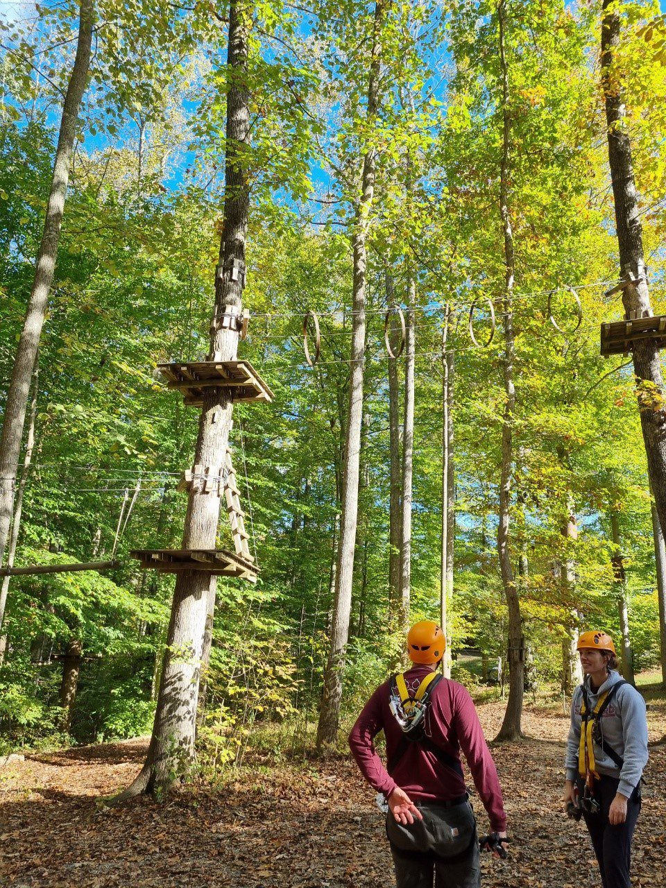 Two students preparing to zipline
