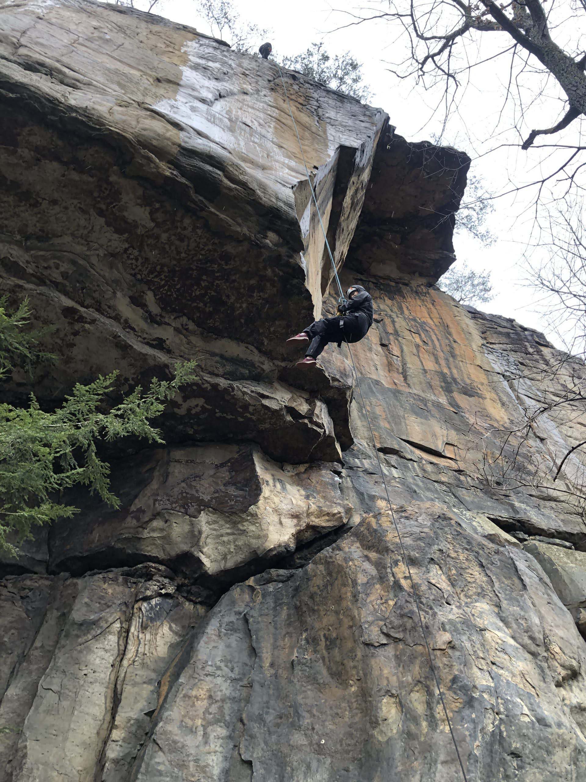 A student rock climbing