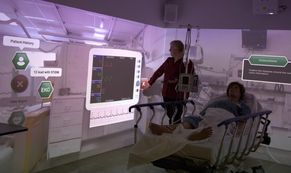 A member of the nursing faculty demonstrates the interactive walls in the Virtual Reality Immersion Lab.