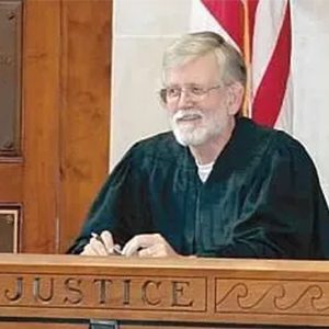 Judge John Frazier sitting in the judge's bench