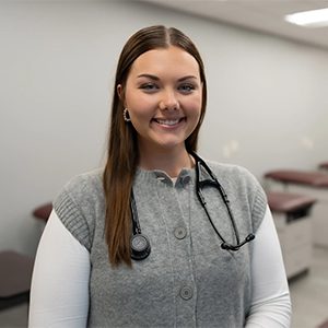 Kelly Pruett wearing a stethoscope in a PA classroom